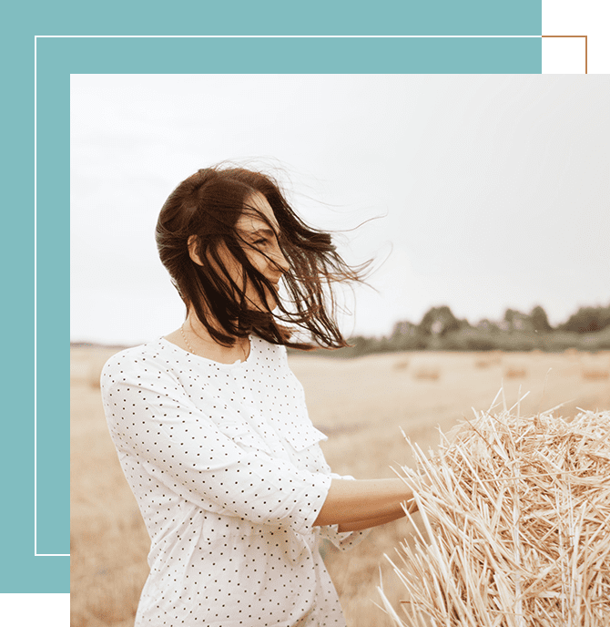 A woman standing in the middle of a field.